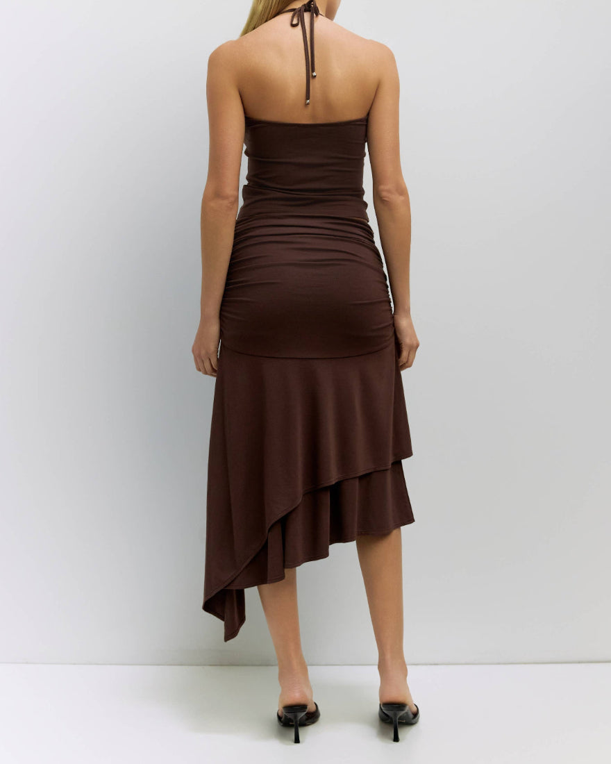 Woman wearing a brown dress with a white background
